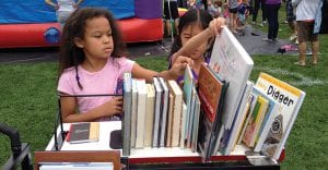 Two girls selecting books from the Book Bike