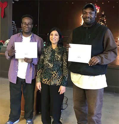 Adult Education and Job Seekers Librarian Rashmi Swain poses with two recent graduates of Housing Forward’s Career Passport program.