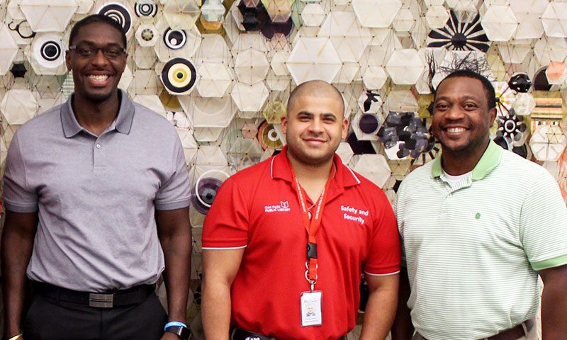 Social Services Specialist Stephen Jackson, Supervisor of Safety and Security Aaron Alonzo, and Social Services Director Robert Simmons
