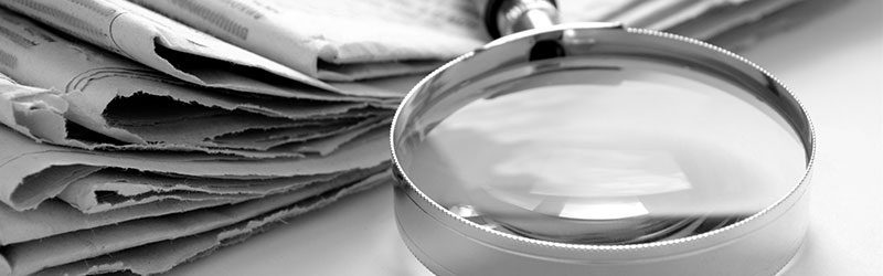 Magnifying glass on newspapers