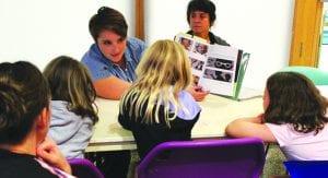 Librarian Naomi Priddy reads with families in a Race Conscious Readers workshop
