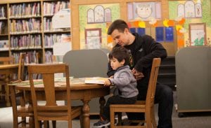 Father and son reading at Maze Branch