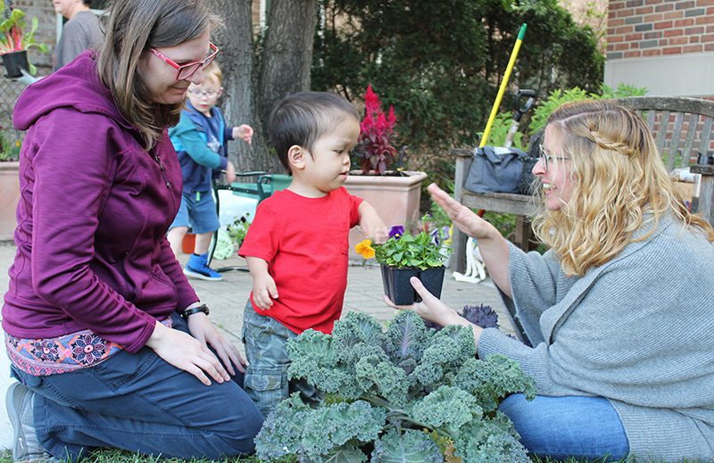 Adults and kids gardening at Maze Branch