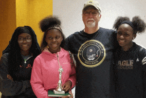 Chess players pose with trophy