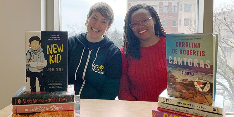 Librarians Jenna and Dontaná with books