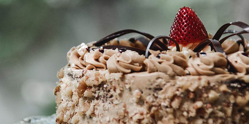 Cake decorated with chocolate and a strawberry