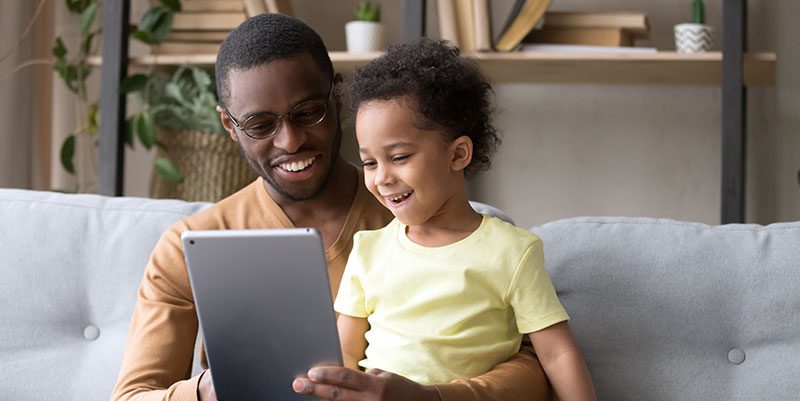 Parent and child looking at tablet