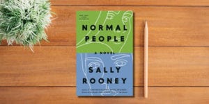 Sally Rooney on table with plant and pencil