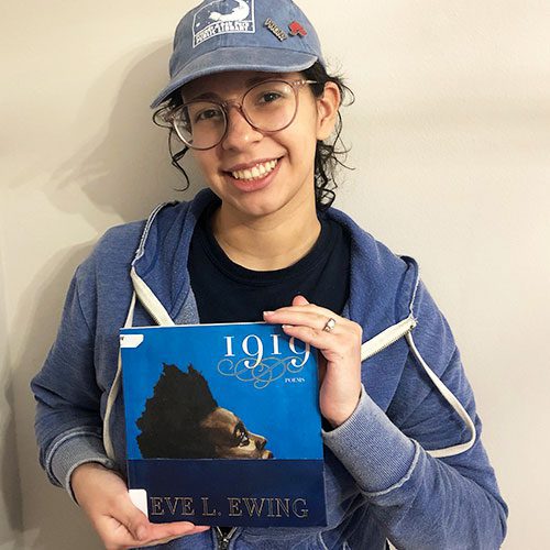 Middle School Services Librarian Beronica holding 1919