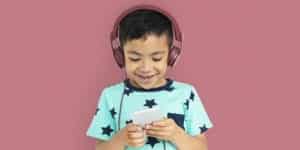Kid with headphones listening to podcast