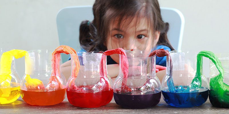 Child looking at beakers