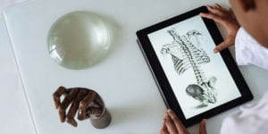 Kid looking at anatomy on tablet