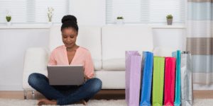 Woman with laptop and gift bags