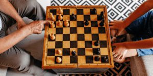 Wooden chess board with two players