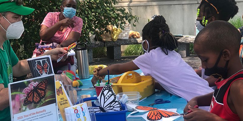 Kids and adults do butterfly craft projects