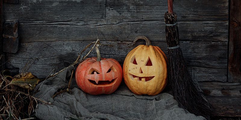 Two jack-o-lanterns with broom