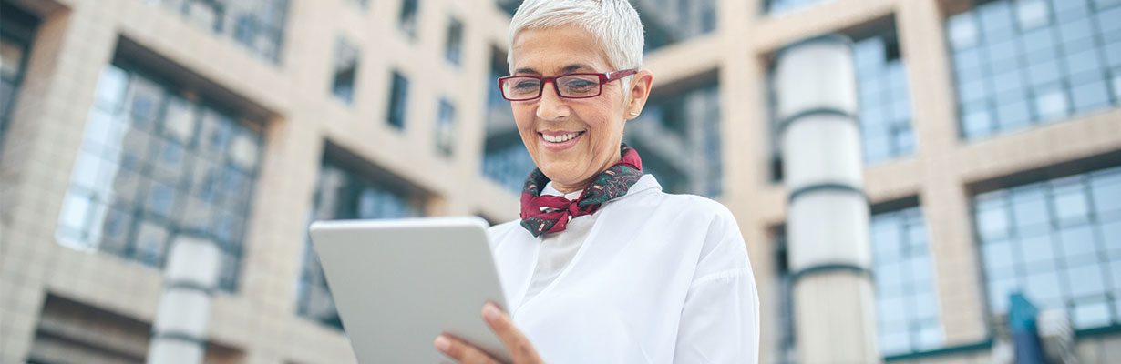 Patron holding iPad and smiling