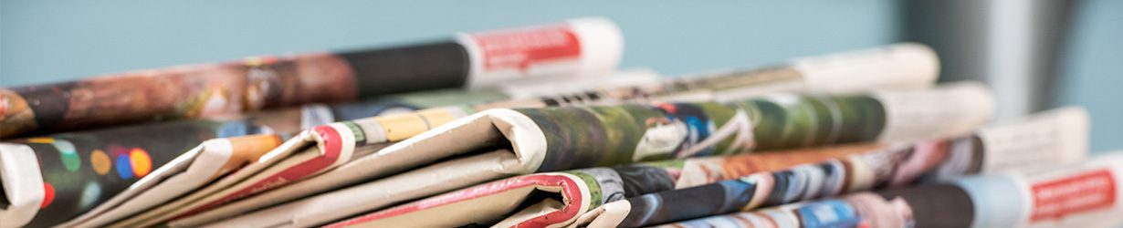 Stack of newspapers fanned out on a surface
