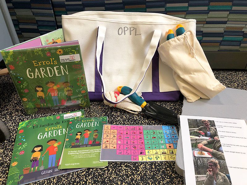 A tote bag with books, gardening tools, instructions, and more.