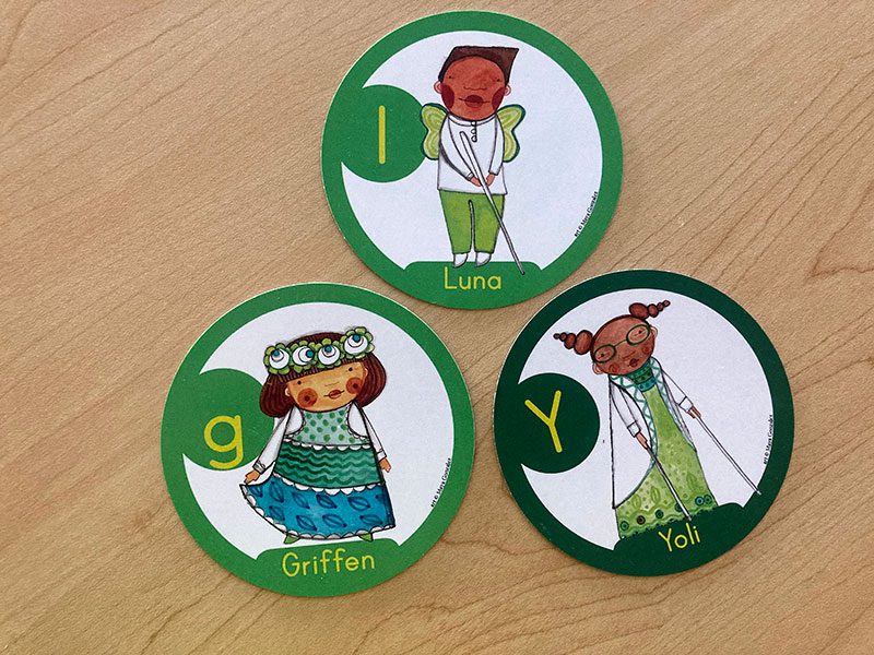 Three Pronoun Kid cards face up on a table