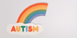 Autism with cut paper rainbow on a cloud