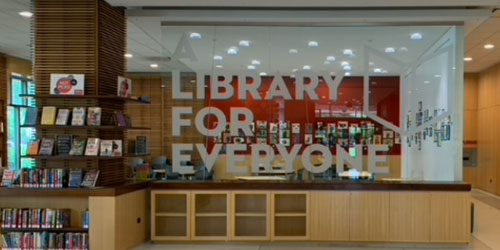 A Library for Everyone signage on glass in library lobby