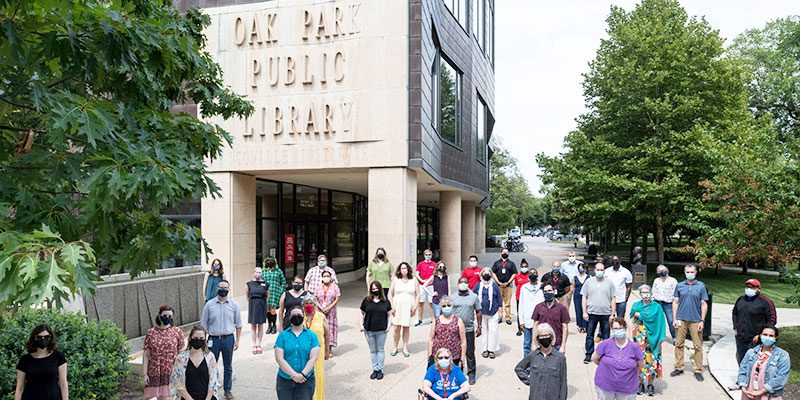 Staff standing in front of Main Library entrance