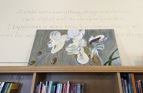 Painting of orchids above bookshelf