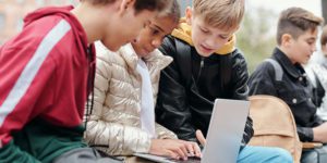 Three kids studying on a laptop