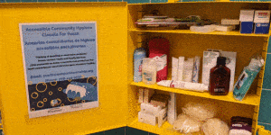 Cabinet in restroom stocked with hygiene supplies and toiletries