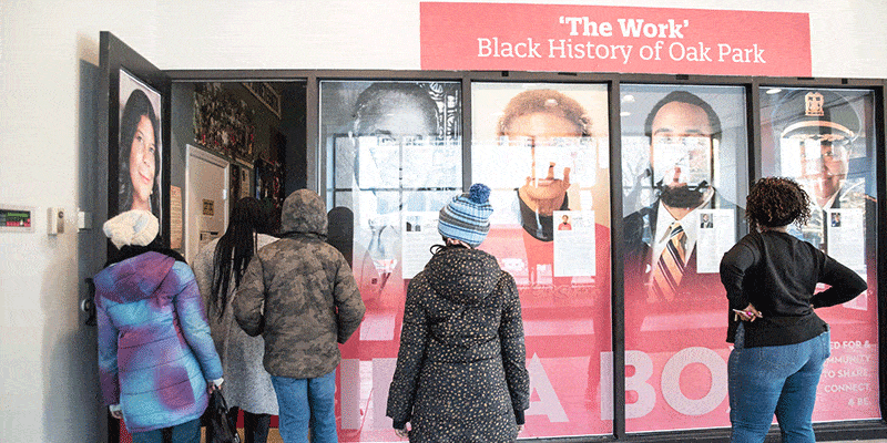 People stand outside the February Idea Box exhibit, "The Work": Black History Museum