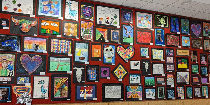 Oak Park Elementary School District 97 student artwork hanging on Main Library Lobby Community Space wall