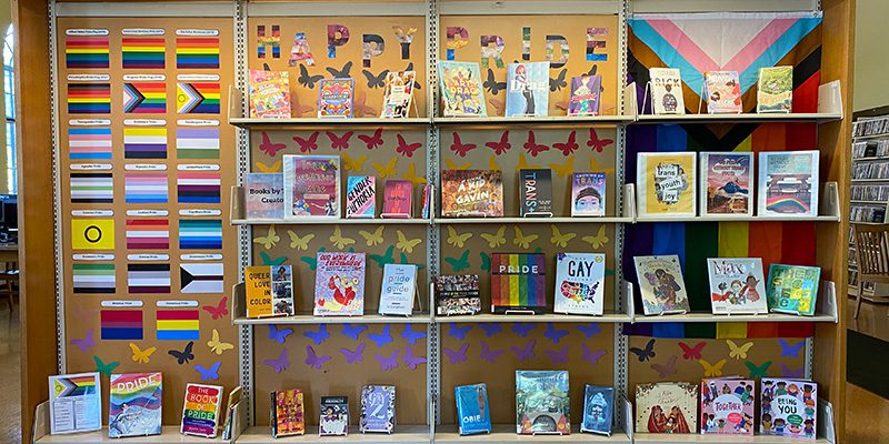 Display of Pride Month books and flags
