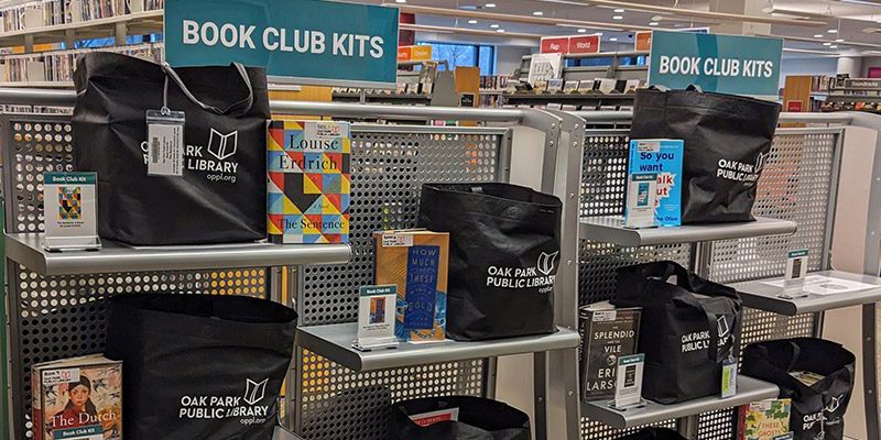 Book Club Kit books and tote bags on shelves