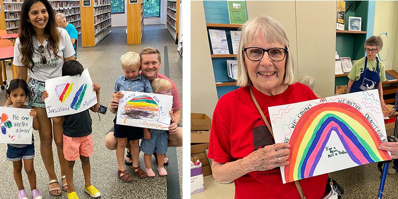 Patrons in the library hold signs they made for Disability Pride Month