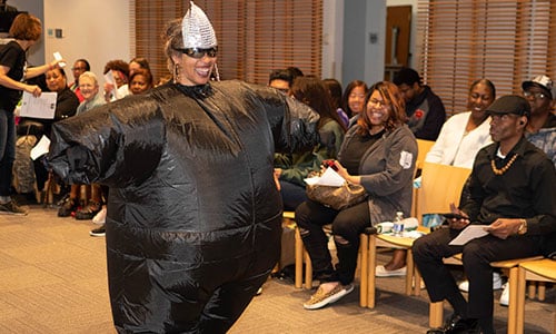 Library staff wears Missy Elliot inflatable suit at hip hop fashion show