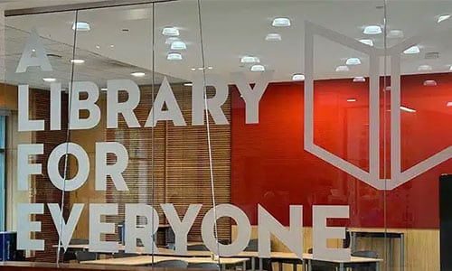 Words "A Library for Everyone" on glass in the Main Library lobby