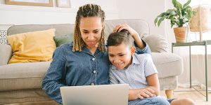 Parent and child using laptop together