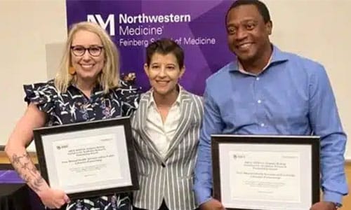 Ashley Knapp and Rob Simmons accept award, with a backdrop reading Northwestern Medicine Feinberg School of Medicine