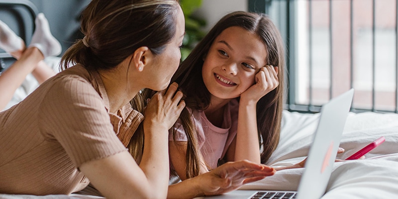 Caregiver and kid sharing laptop