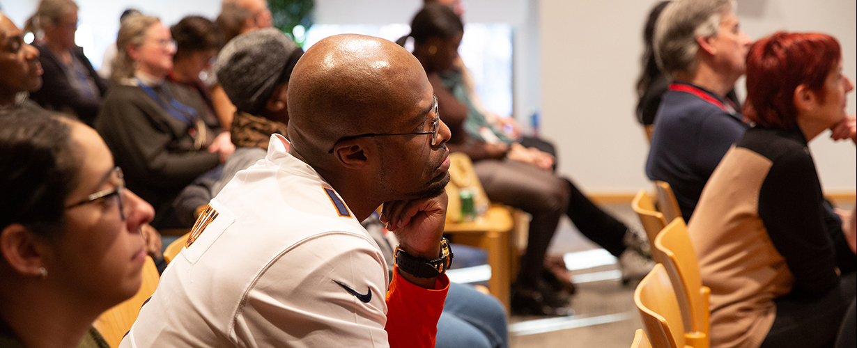 Audience members listening