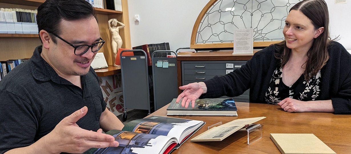 Two people looking at items in Special Collections