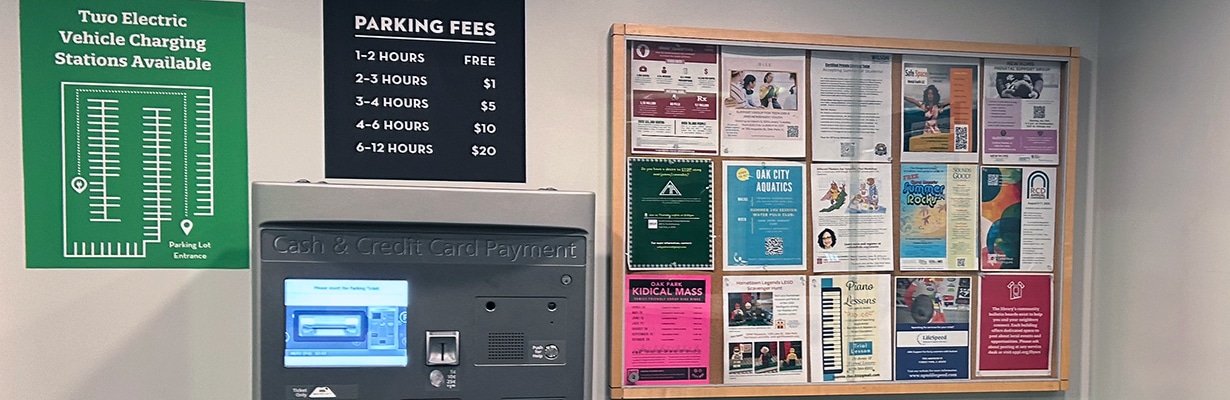 Main Library garage level vestibule with community flyers on a bulletin board