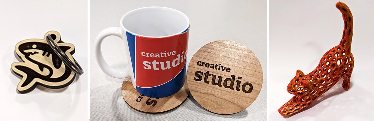 Collage of items made in the Creative Studio: A wooden shark keychain, a mug with a coaster, and a 3d-printed cat