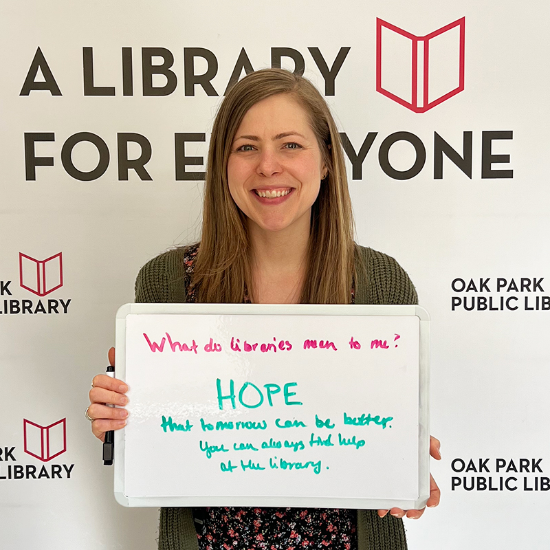 Library staff member holding a sign that reads, Hope that tomorrow can be better. You can always find help at the library.