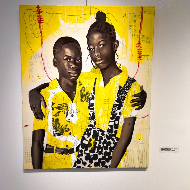 artwork of two african-american children holding each other wearing yellow and black