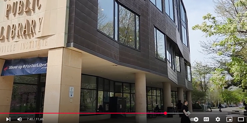 Person leaves the library with a book.