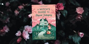 Book cover for A Witch's Guide to Magical Innkeeping with a dark floral background behind