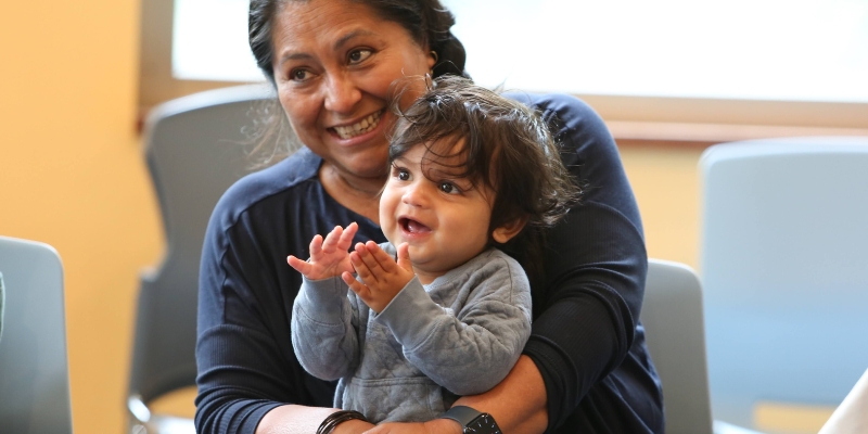 Child and adult smiling in a storytime.