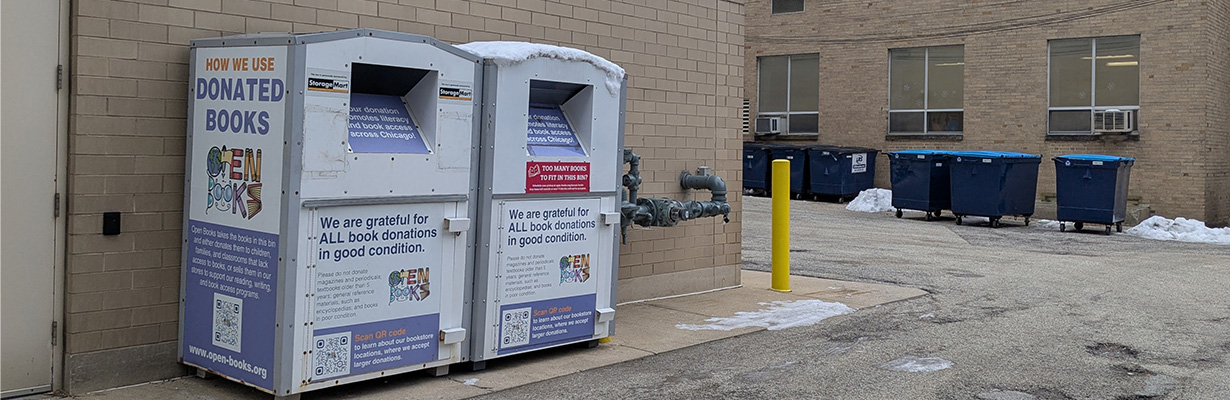 Open Books donation bins in alley.